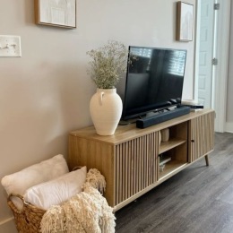 a living room with a tv on a media console
