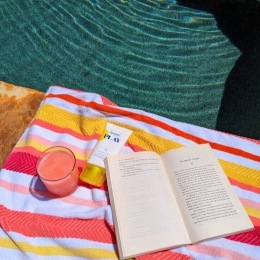a pool with a book on a blanket