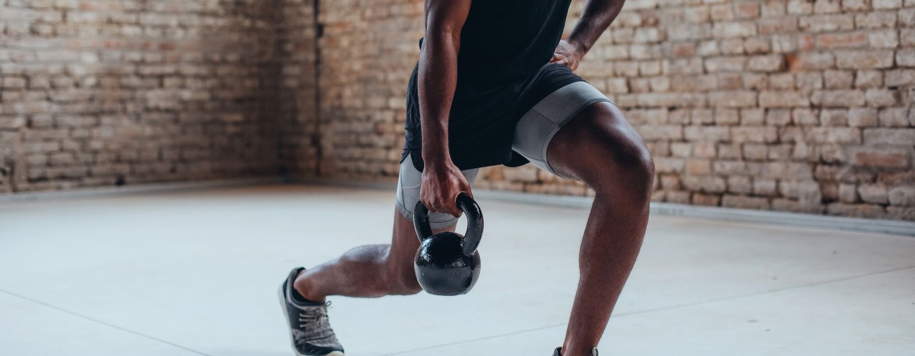a man doing lunges with kettlebell